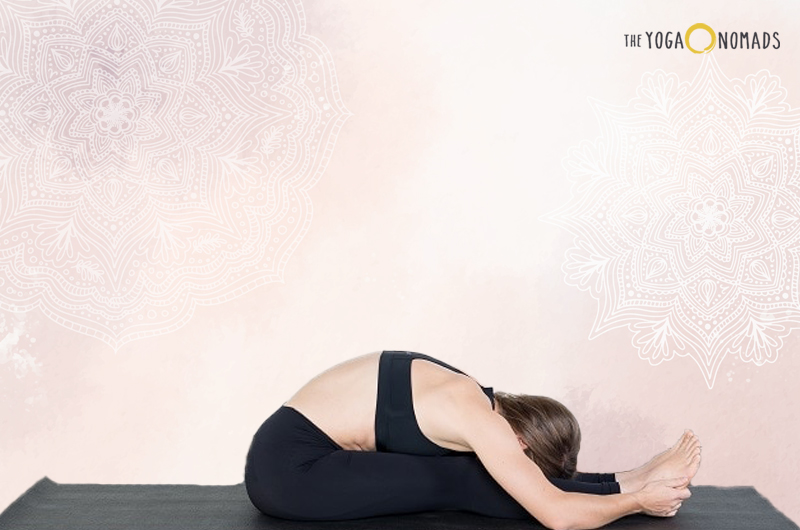woman performing a seated forward bend pose