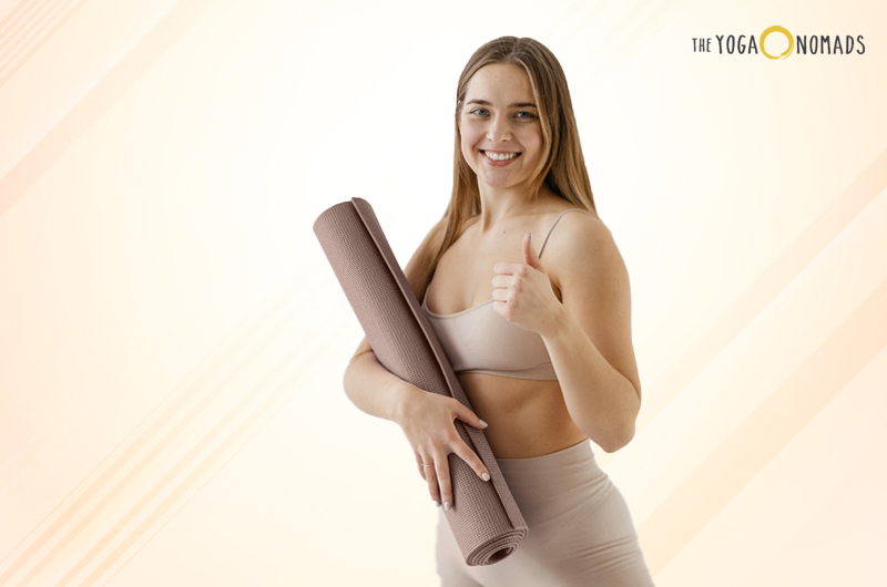 how thick should a yoga mat be: woman holding a yoga mat with a smile
